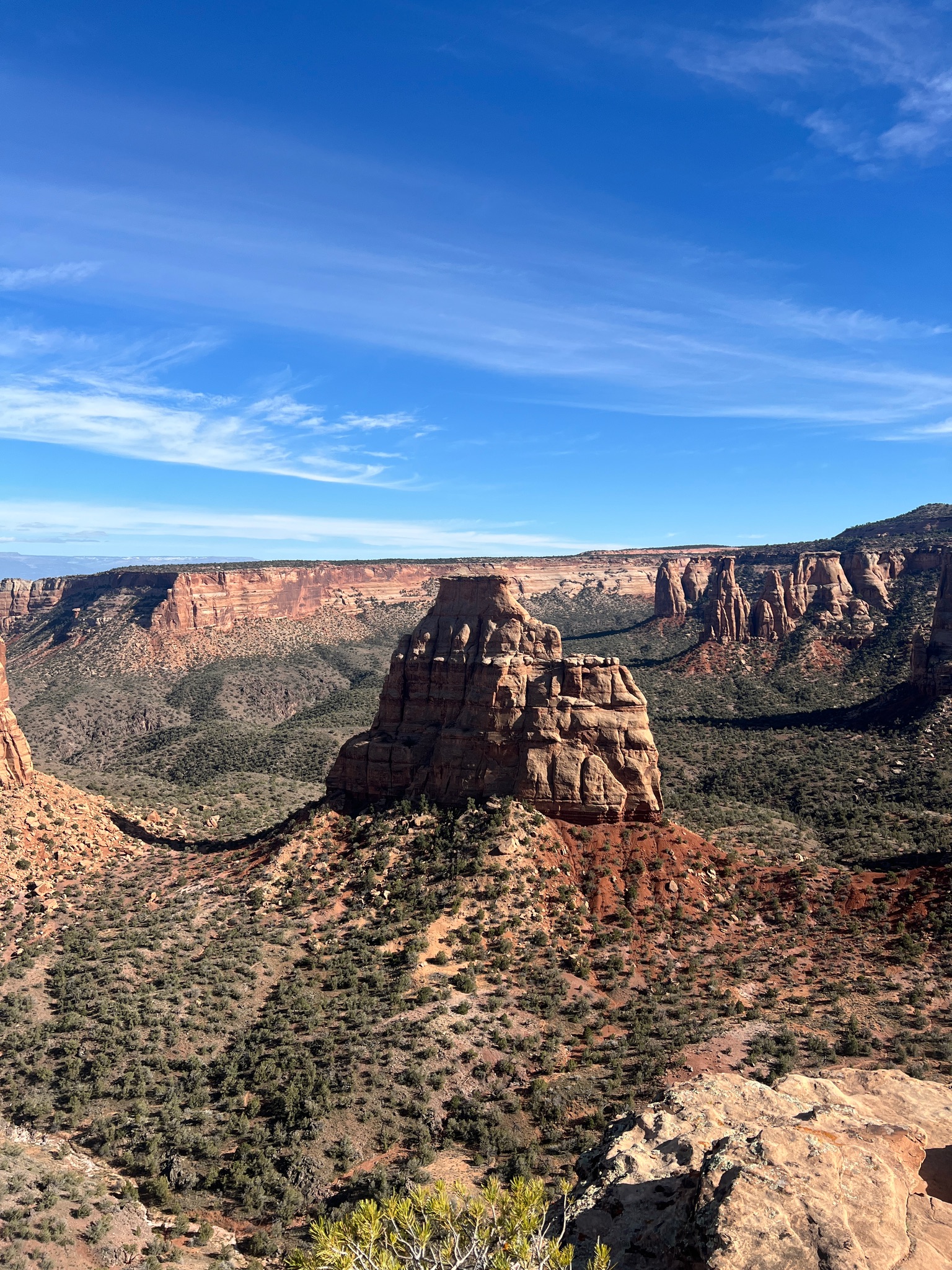 A towering rock formation in a valley in the National Monument, Colorado
