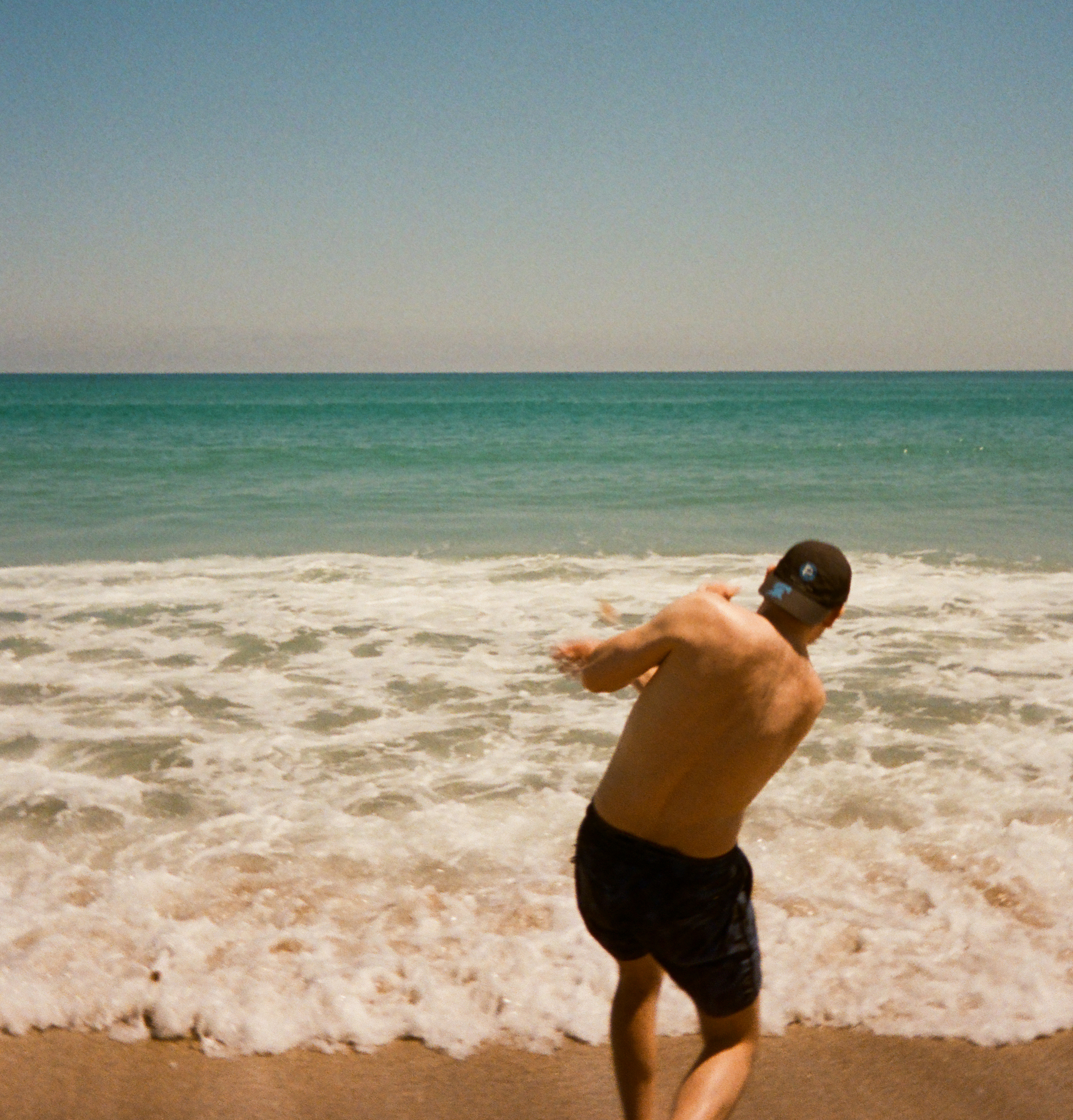 The author skipping a rock on a beach